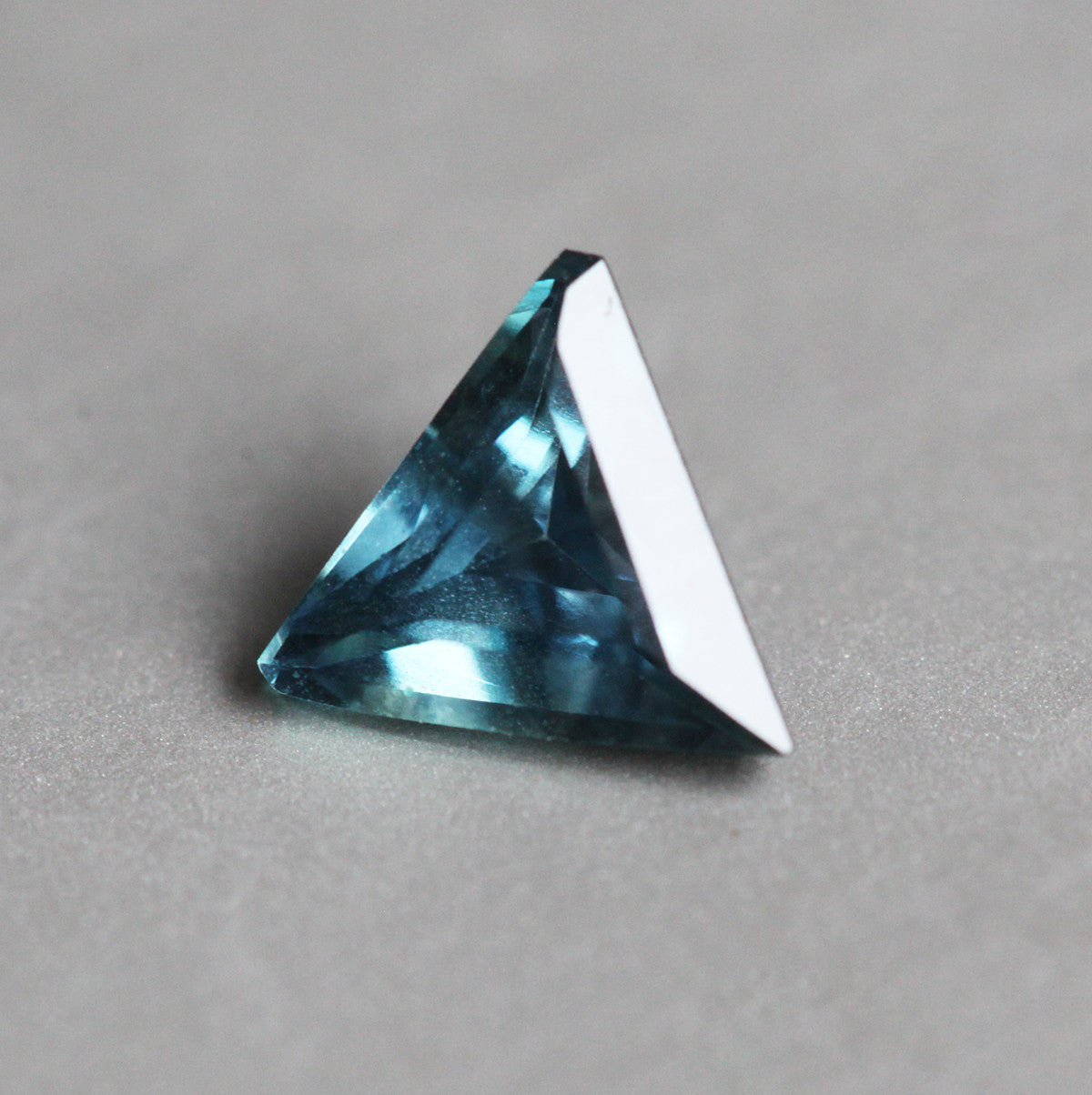 Loose triangle-shaped teal sapphire