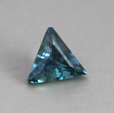 Loose triangle-shaped teal sapphire
