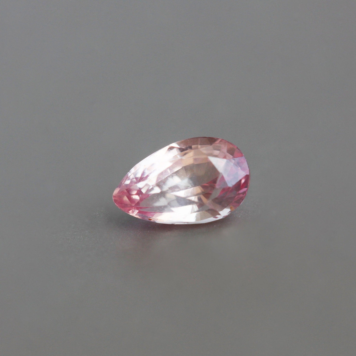 Loose pear-shaped pink and orange sapphire