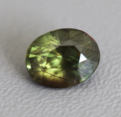 Loose oval-shaped yellow green sapphire