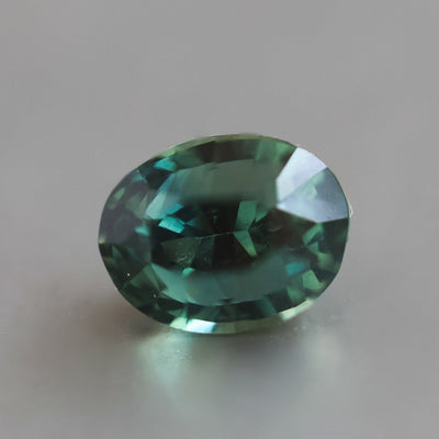 Loose oval-shaped teal sapphire