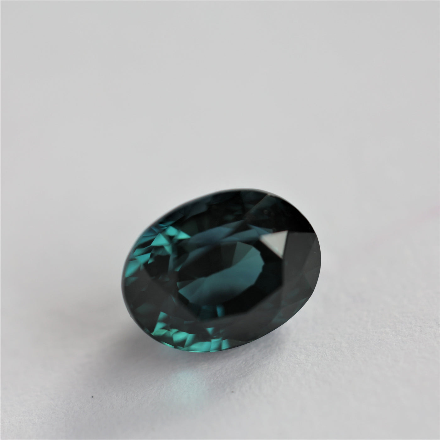 Loose oval-cut teal sapphire