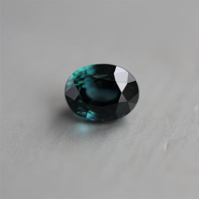 Loose oval-cut teal sapphire