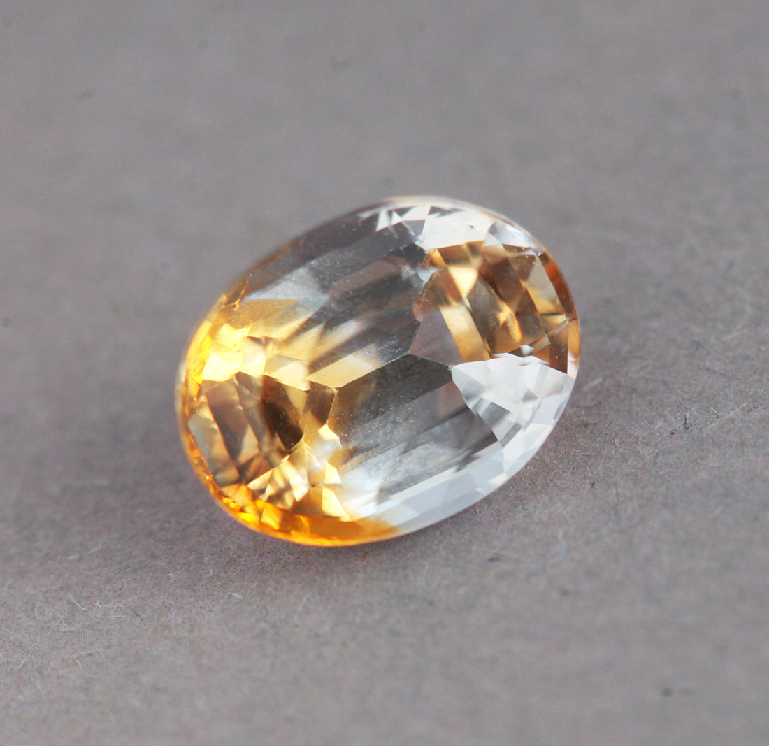 Loose oval-shaped yellow and colorless sapphire