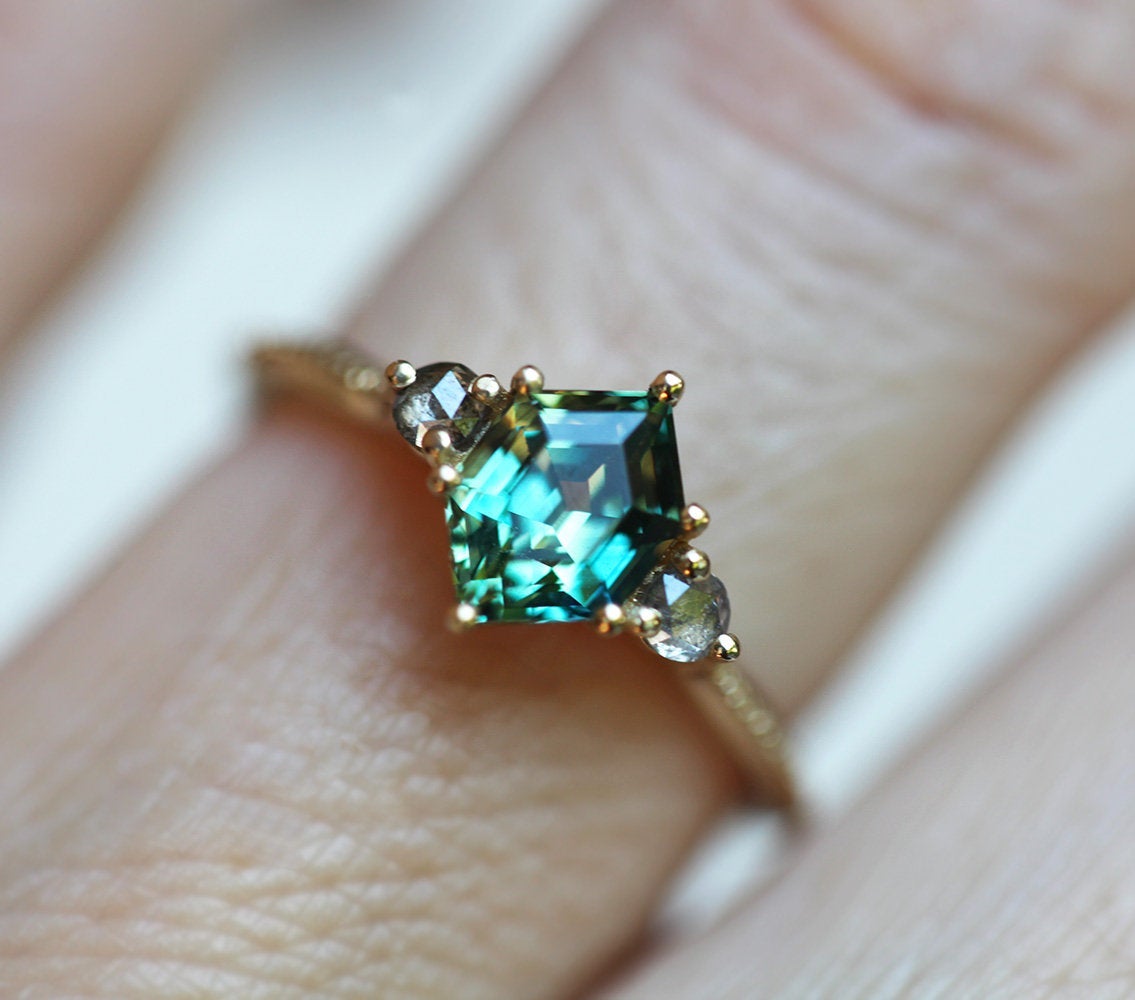 Hexagon-shaped green sapphire ring with salt and pepper diamond side stones