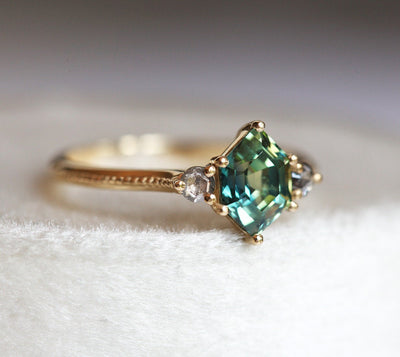 Hexagon-shaped green sapphire ring with salt and pepper diamond side stones