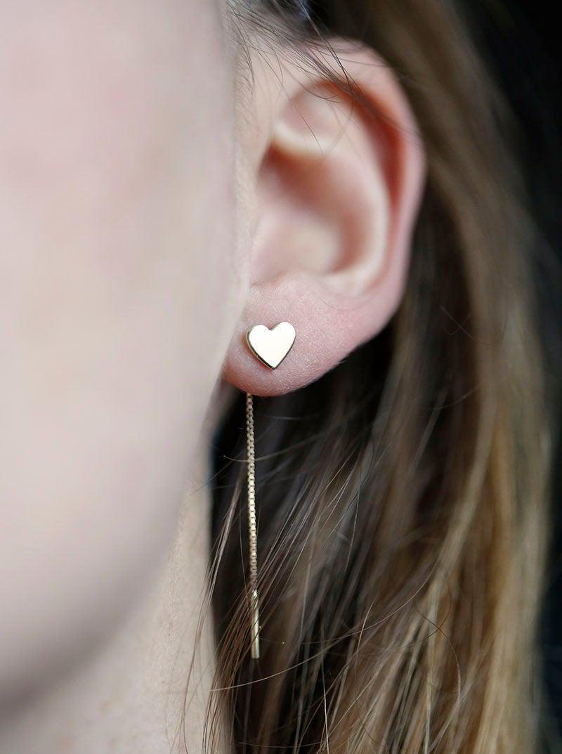Heart-shaped gold stud earrings with dangling chain