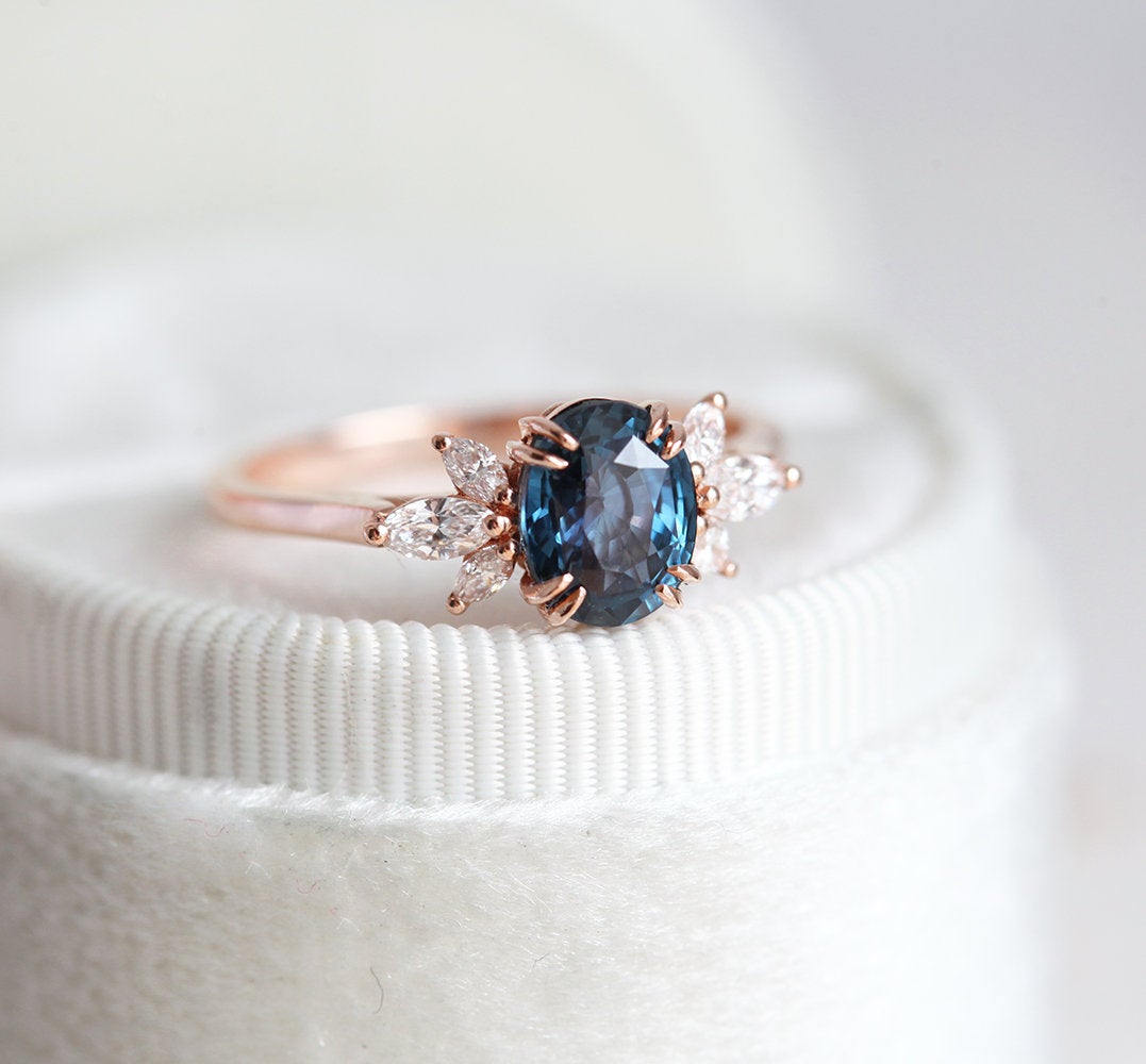 Oval-shaped blue ceylon sapphire ring with side diamonds