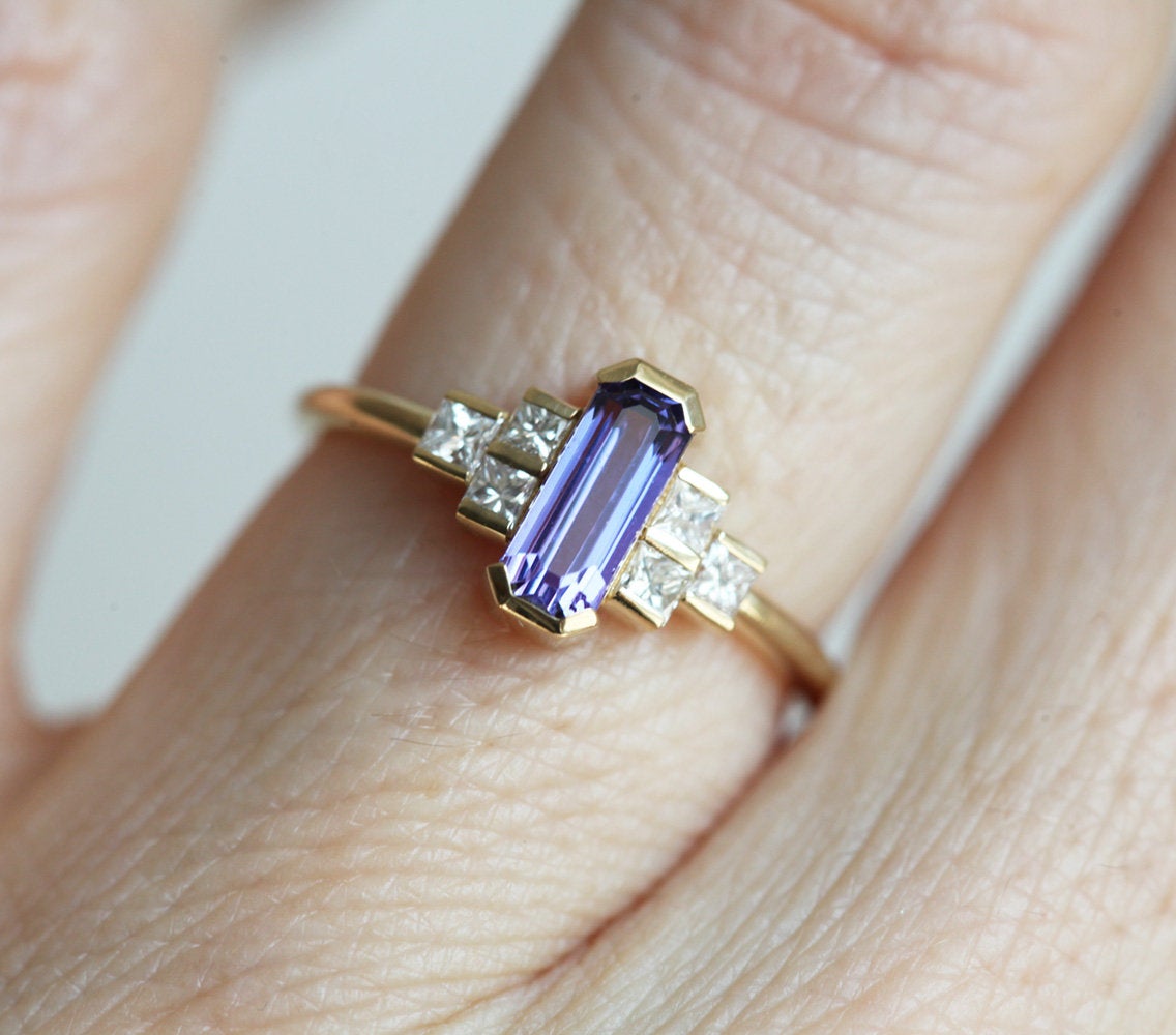 Octagon-shaped emerald-cut lavender sapphire ring with white side diamonds