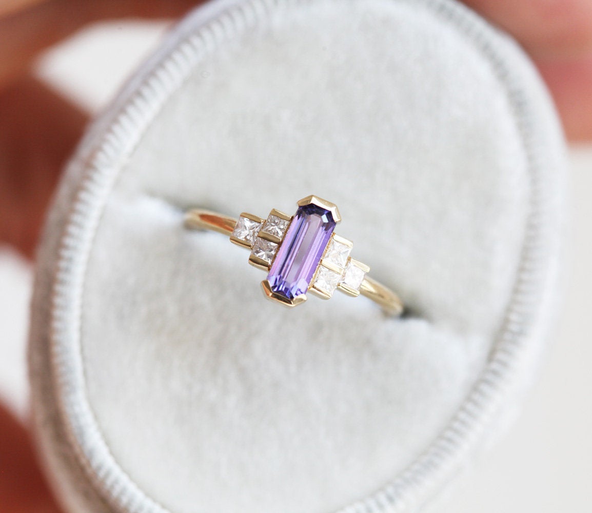 Octagon-shaped emerald-cut lavender sapphire ring with white side diamonds
