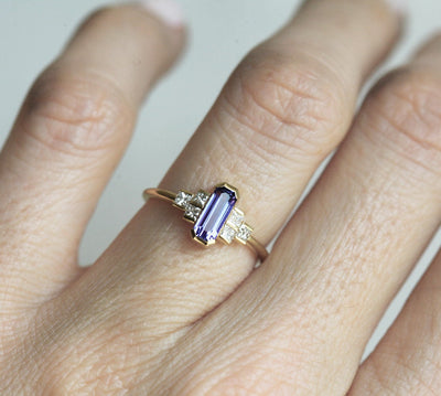 Octagon-shaped emerald-cut lavender sapphire ring with white side diamonds