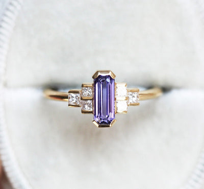 Octagon-shaped emerald-cut lavender sapphire ring with white side diamonds