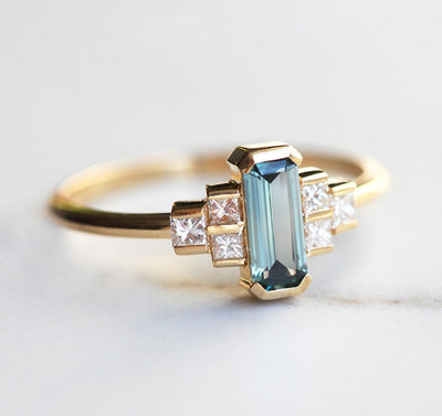 Emerald-cut teal sapphire art deco ring with white side diamonds