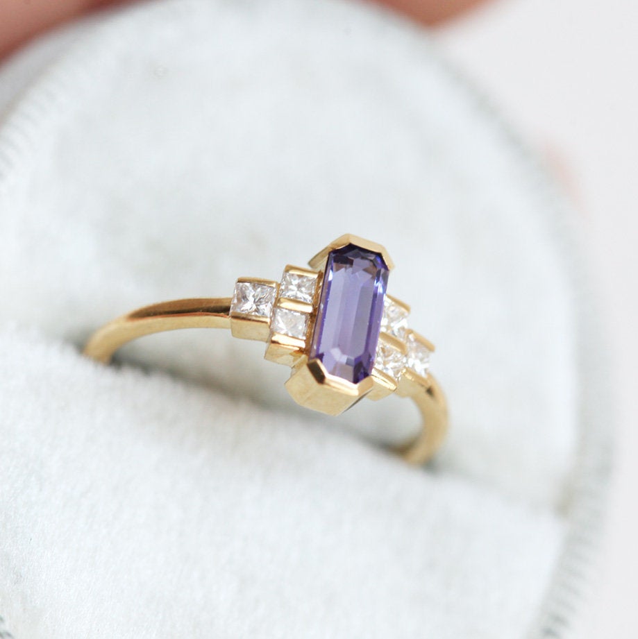 Octagon-shaped emerald-cut lavender sapphire ring with white side diamonds