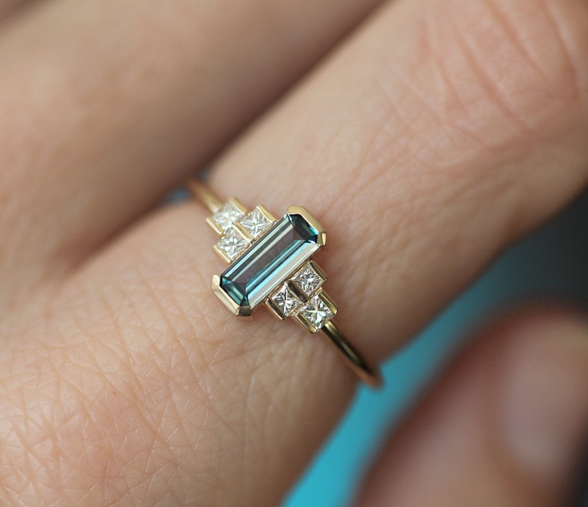 Emerald-cut teal sapphire art deco ring with white side diamonds