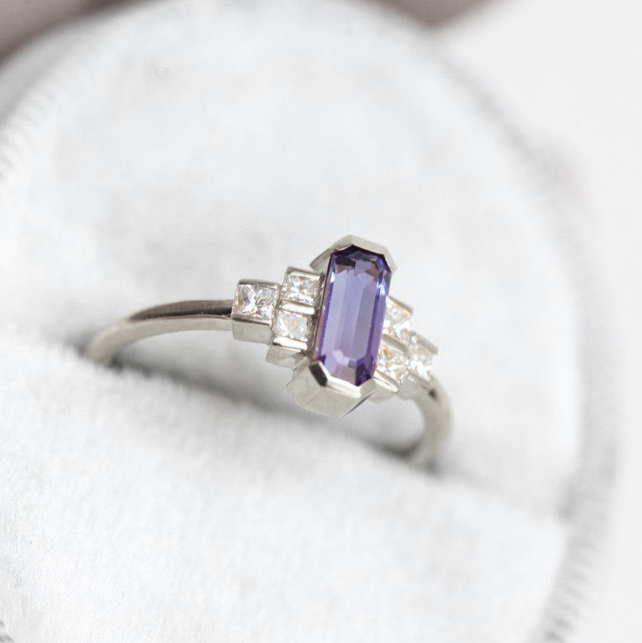Octagon-shaped emerald-cut lavender sapphire ring with white side diamonds