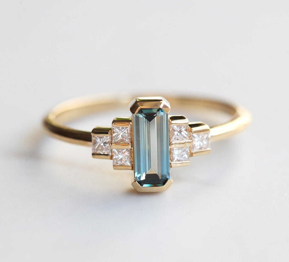 Emerald-cut teal sapphire art deco ring with white side diamonds