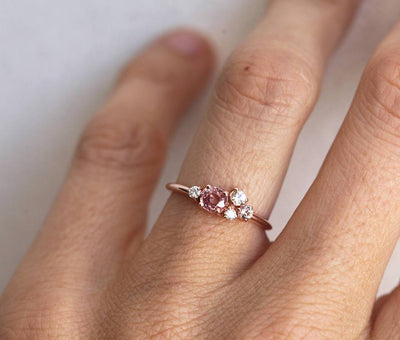 Round peach pink sapphire cluster ring with diamonds