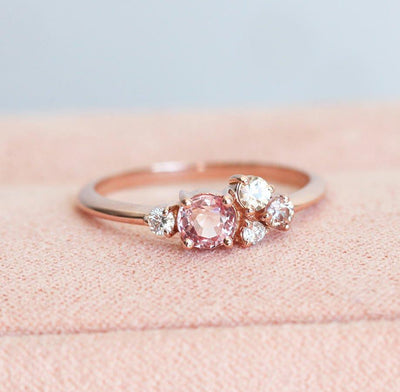 Round peach pink sapphire cluster ring with diamonds