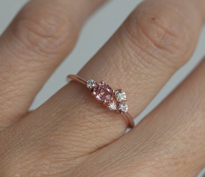 Round peach pink sapphire cluster ring with diamonds