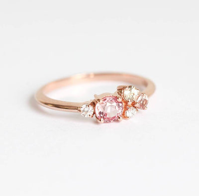 Round peach pink sapphire cluster ring with diamonds