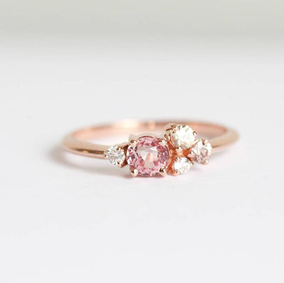 Round peach pink sapphire cluster ring with diamonds