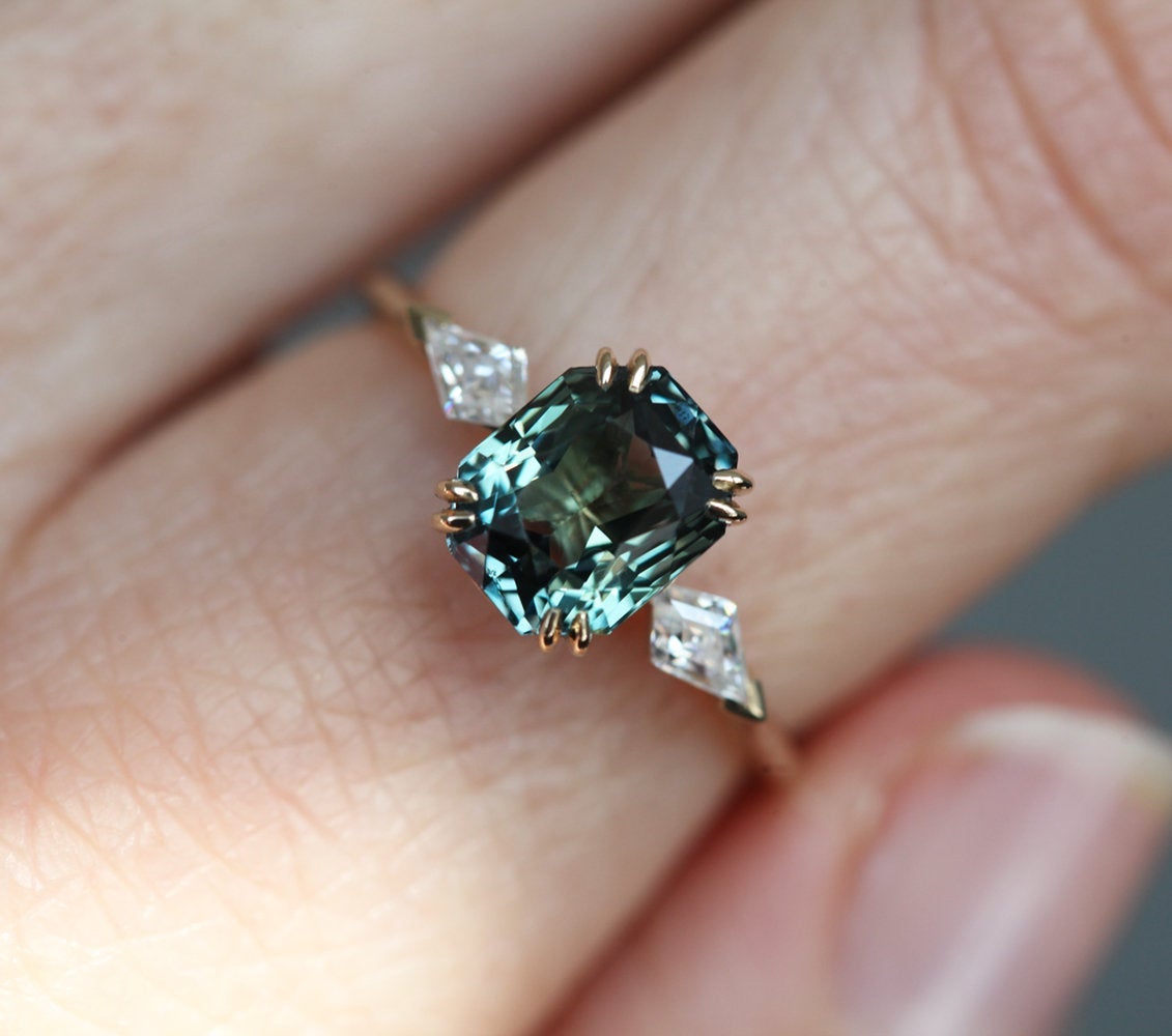 Radiant-cut teal sapphire ring with diamonds