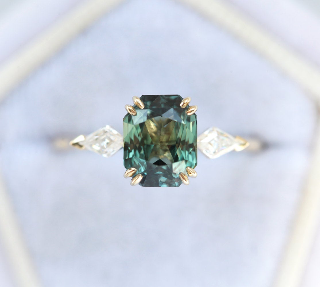 Radiant-cut teal sapphire ring with diamonds