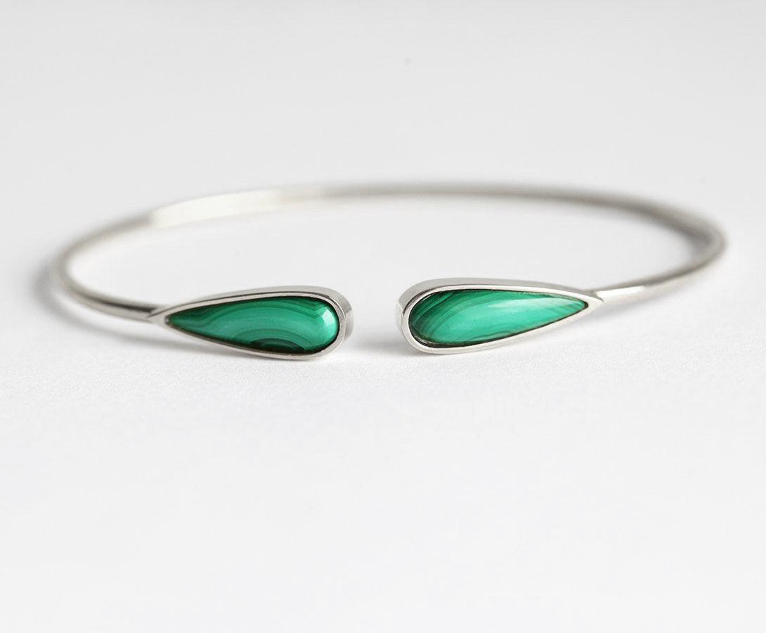 Solid gold cuffed bracelet with two pear-shaped green malachite gems