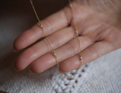 Gold necklace with round white pearl setting