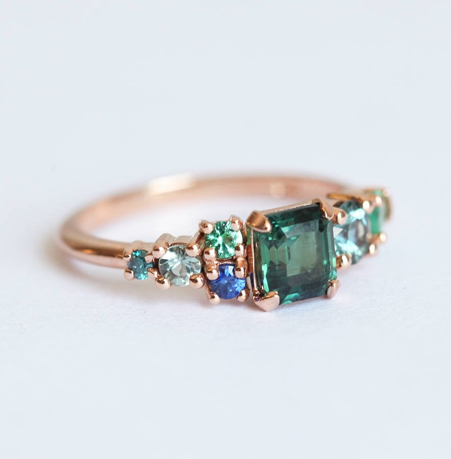 Emerald-cut sapphire cluster ring with emeralds and diamonds