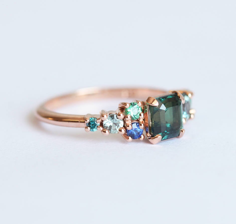 Emerald-cut sapphire cluster ring with emeralds and diamonds