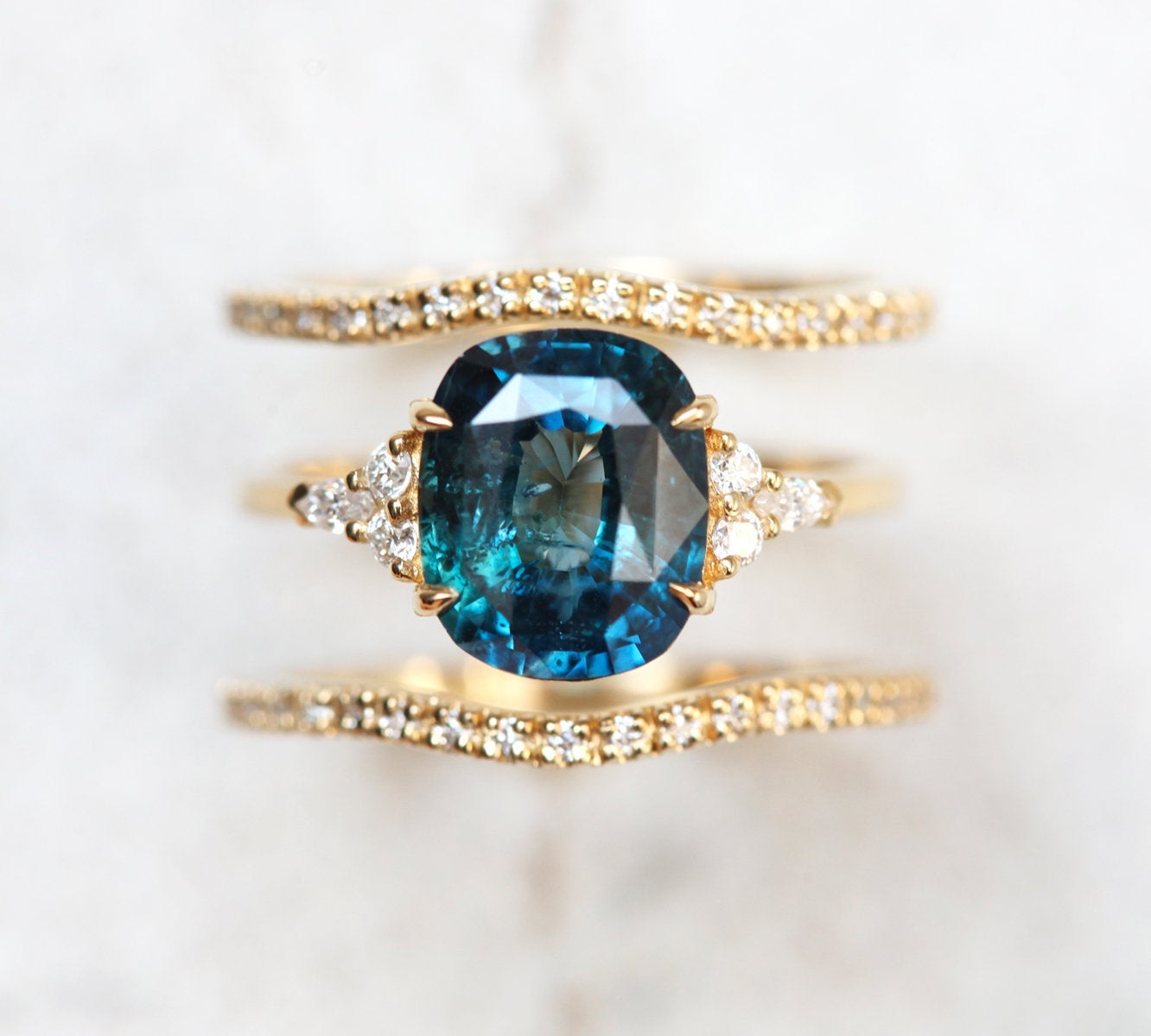 Cushion-cut blue green sapphire cluster ring with diamonds