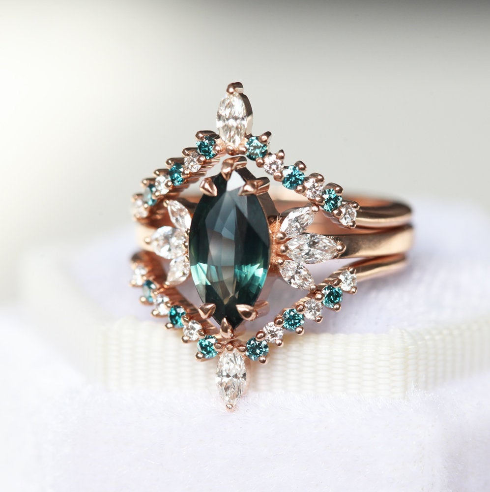 Marquise-cut teal sapphire with white side diamonds