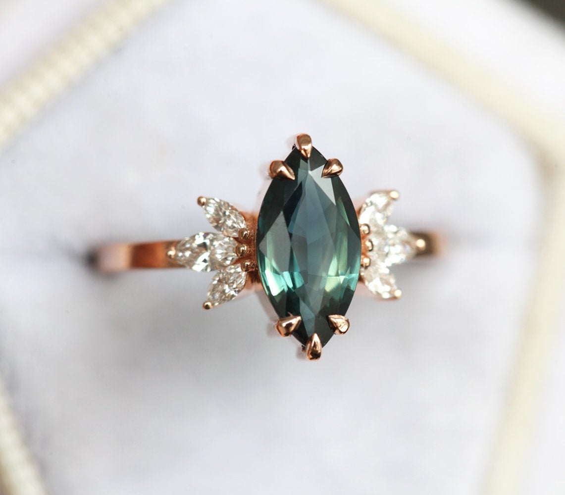 Marquise-cut teal sapphire with white side diamonds