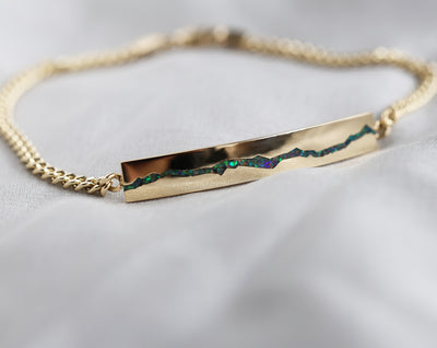 Men's opal inlay bar gold chain bracelet closeup