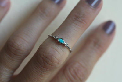 Marquise-cut blue turquoise engagement ring with white side diamonds