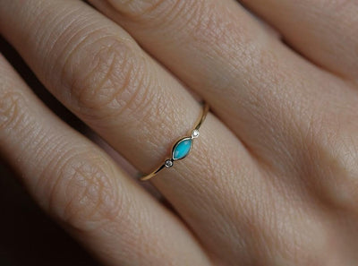 Marquise-cut blue turquoise engagement ring with white side diamonds