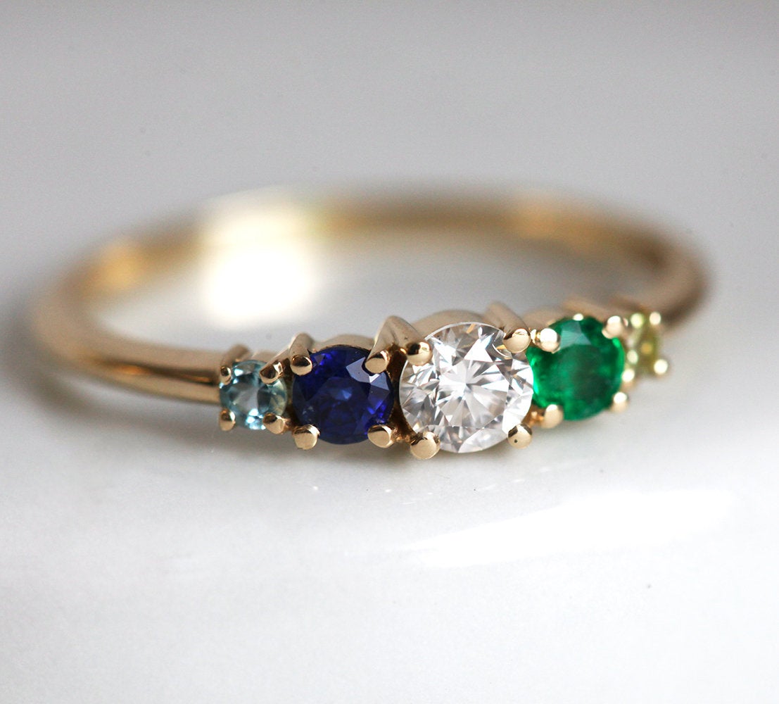 Round diamond cluster ring with sapphire, emerald, peridot and aquamarine gemstones