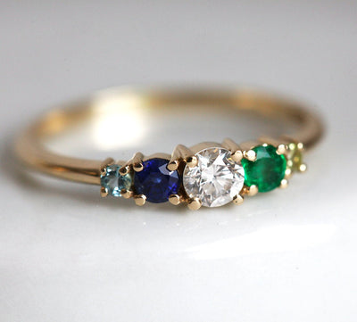 Round diamond cluster ring with sapphire, emerald, peridot and aquamarine gemstones