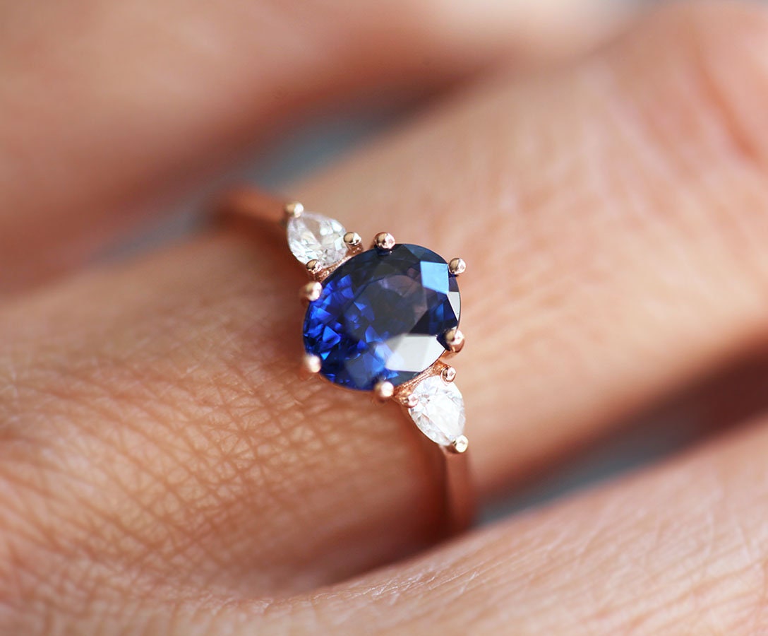 Oval-shaped blue sapphire ring with white side diamonds