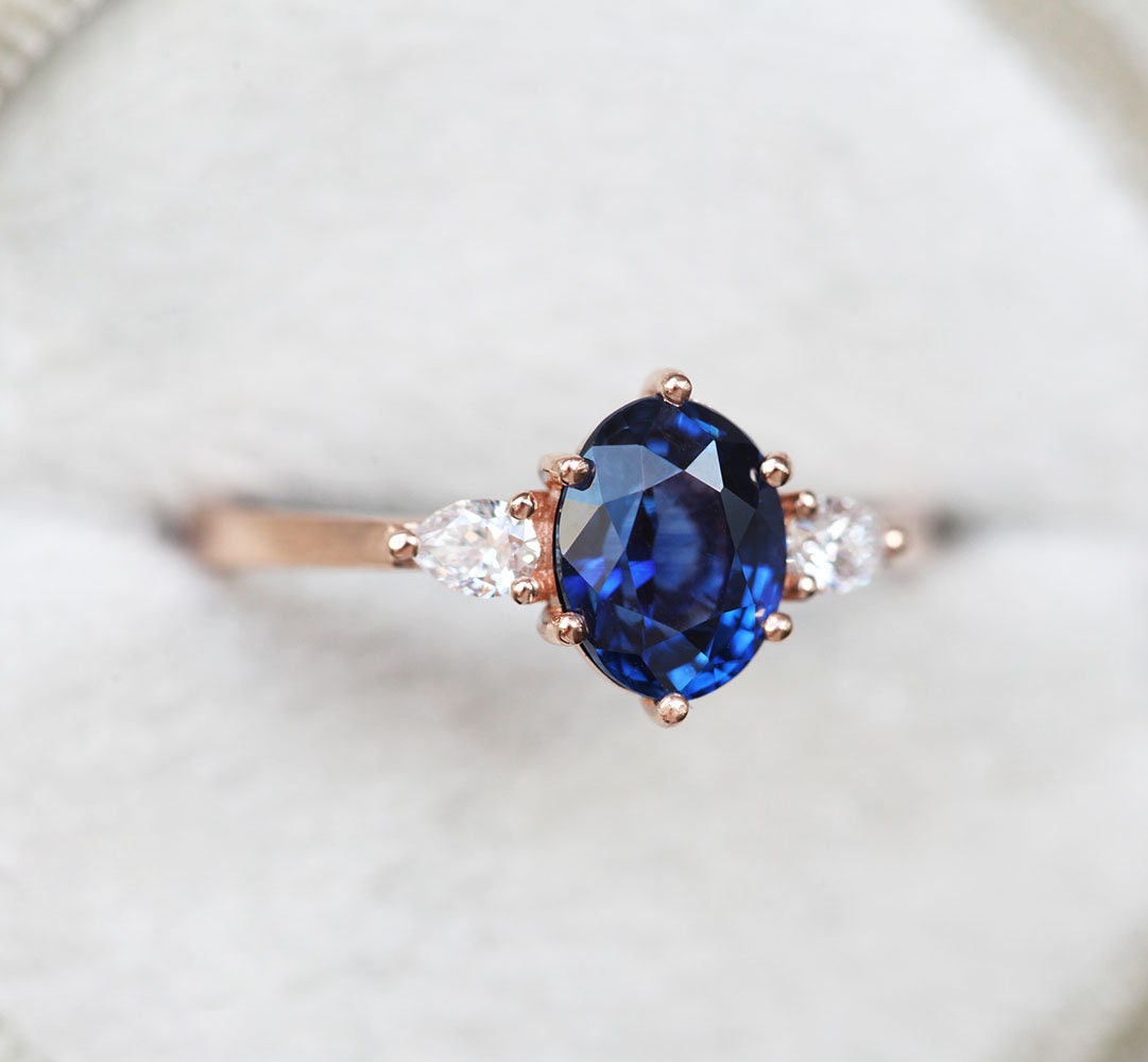 Oval-shaped blue sapphire ring with white side diamonds