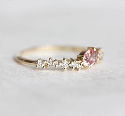 Oval-shaped peach ceylon sapphire cluster ring with diamonds