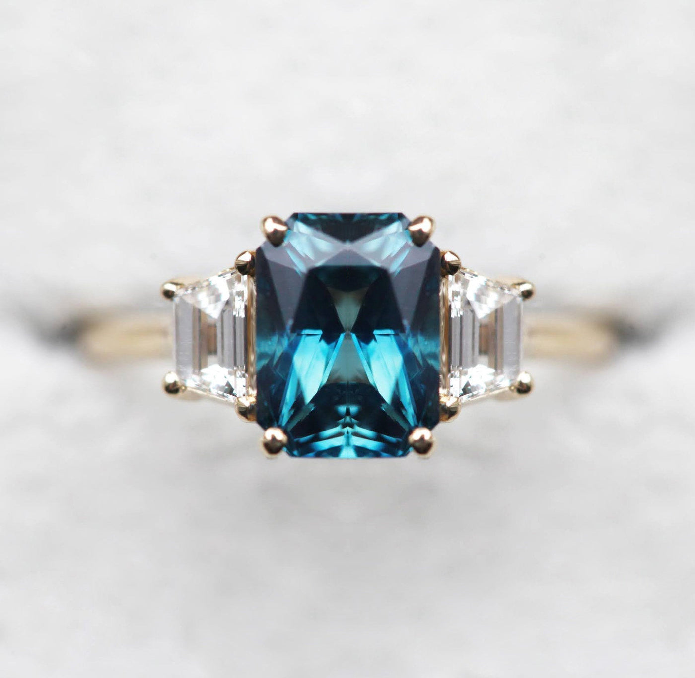 Radiant-cut sapphire ring with side diamonds