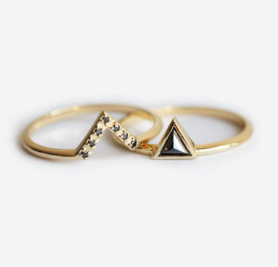 Triangle-shaped black diamond ring and white diamond v-shaped ring