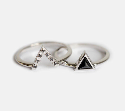 Triangle-shaped black diamond ring and white diamond v-shaped ring