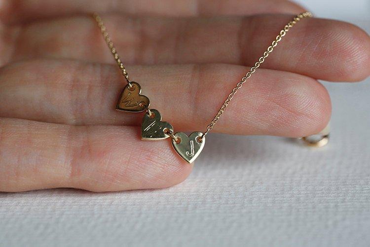 Gold necklace with three small hearts