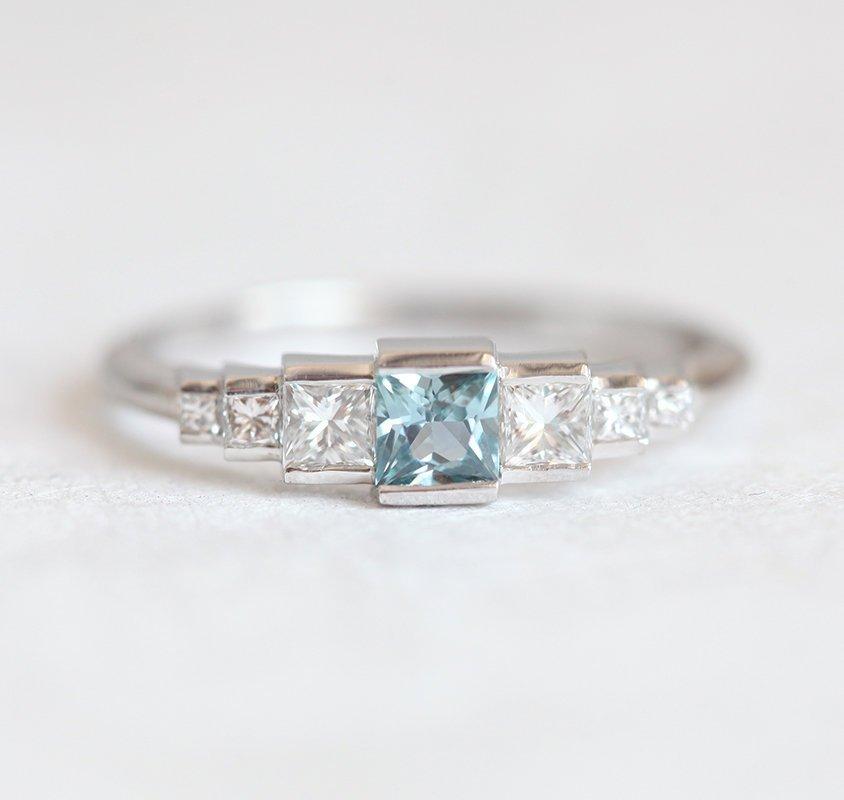 Square-shaped teal sapphire art-deco ring with white side diamonds
