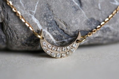 Solid gold moon and stars bracelet with round white diamonds