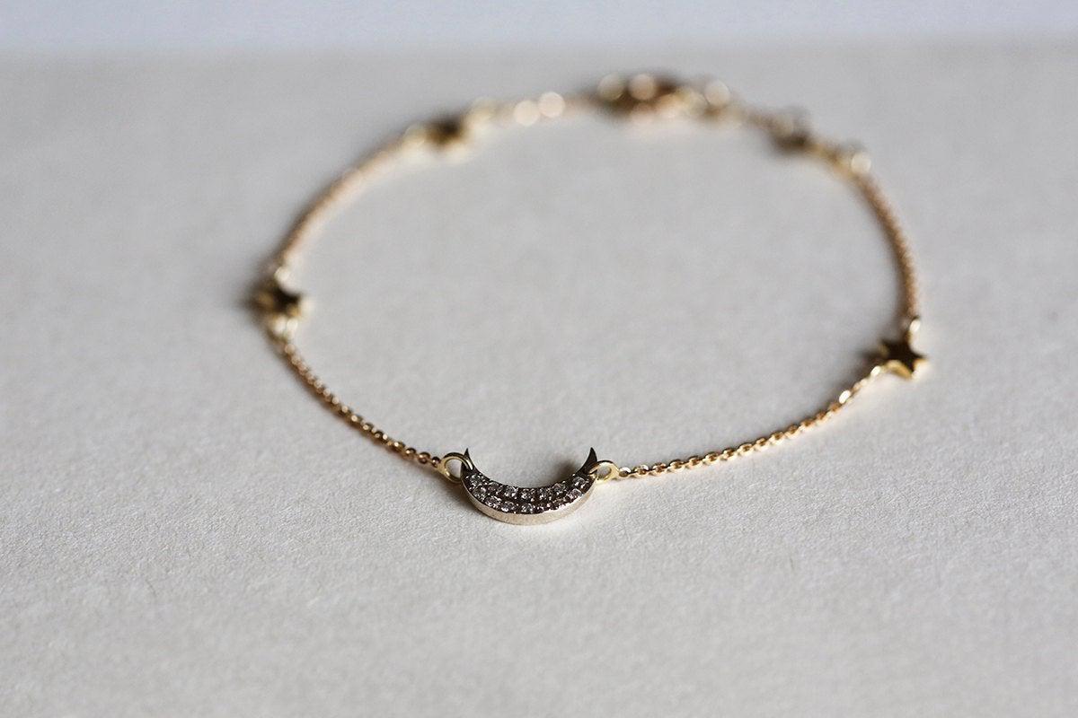 Solid gold moon and stars bracelet with round white diamonds